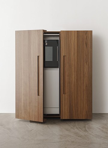 The equipment cabinet easily hides away kitchenware and creates a harmonious atmosphere in the living space