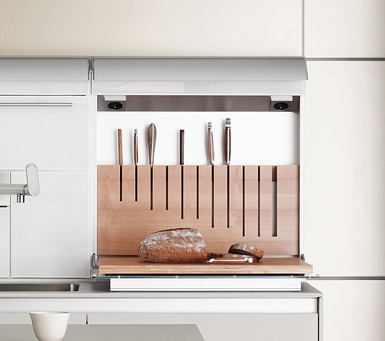 The function box hides a knife block in the wall and contains a chopping board in the flap door